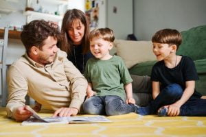 in arrivo lassegno unico per happy family with two little sons reading story indoors parents with children spending time together lying floor home 155404 1375 1